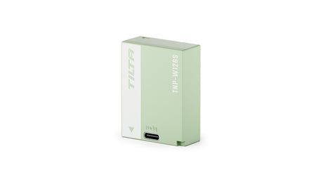 Tilta TNP-W126S 1050mAh camera battery in Ash Green, three-quarter view with the USB-C input port on the front edge